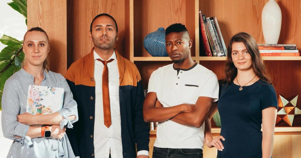A diverse group of professionals posing confidently together in an office setting with bookshelves.