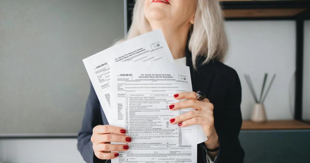 Businesswoman holding tax documents, ready for filing or review, in a professional office setting.
