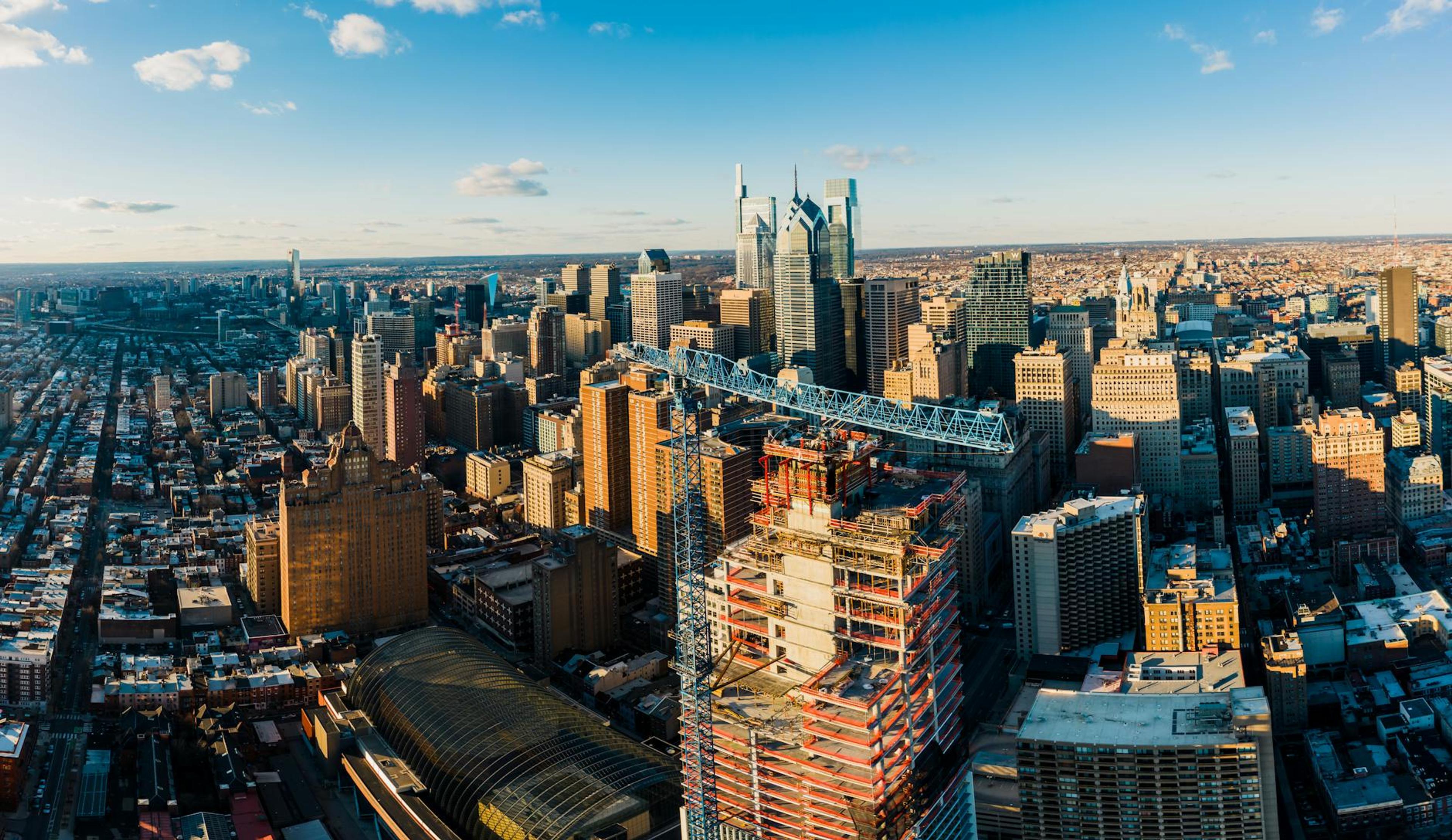 From above of modern district in city with high rise buildings under blue sky in sunny day