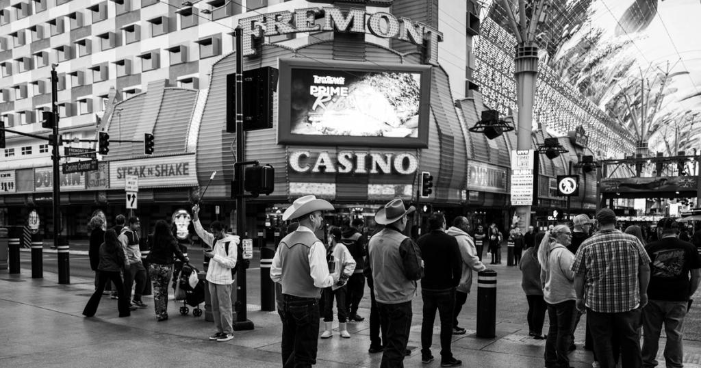 Black and white scene of people on Fremont Street near a casino.