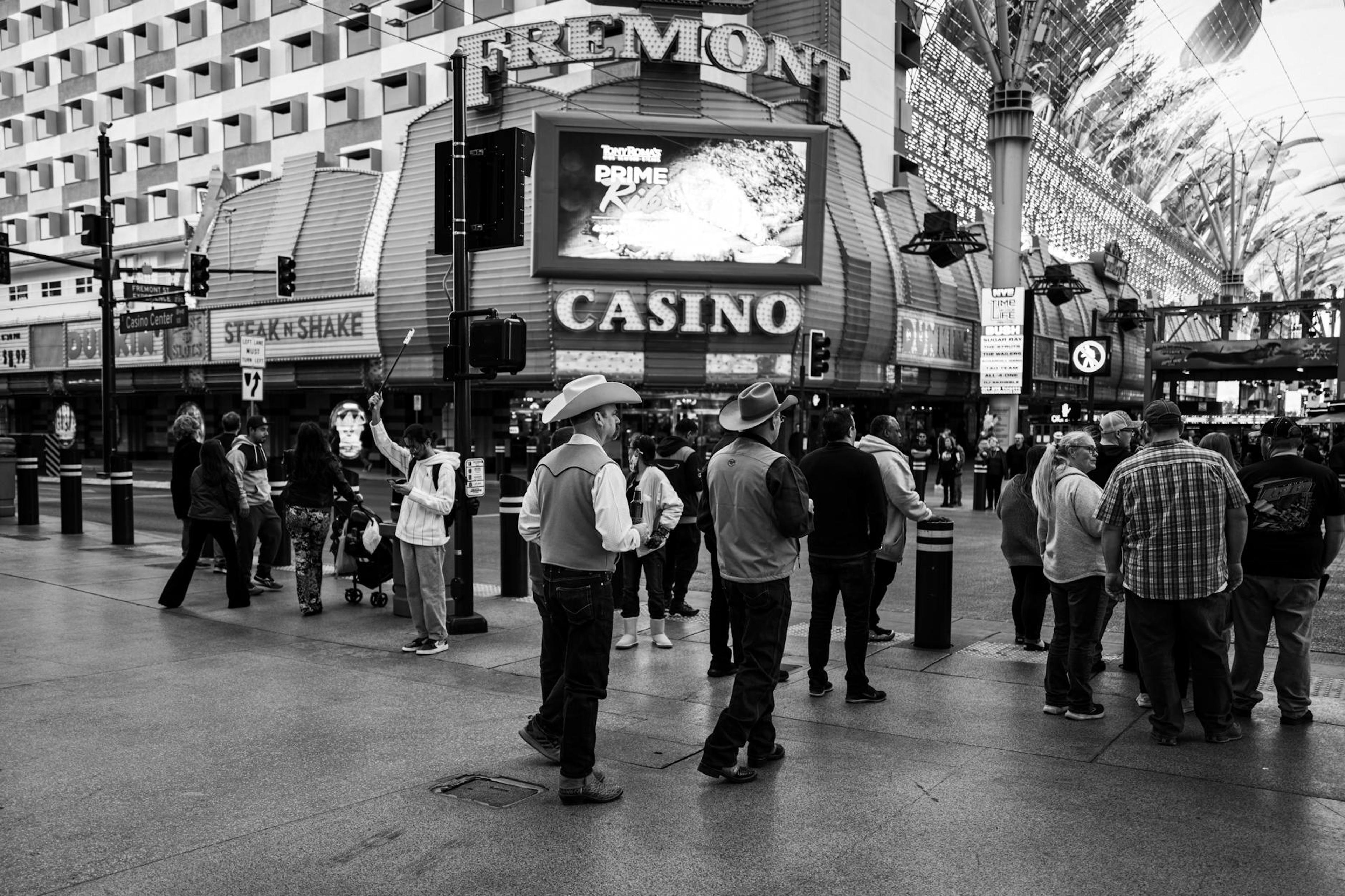 Black and white scene of people on Fremont Street near a casino.