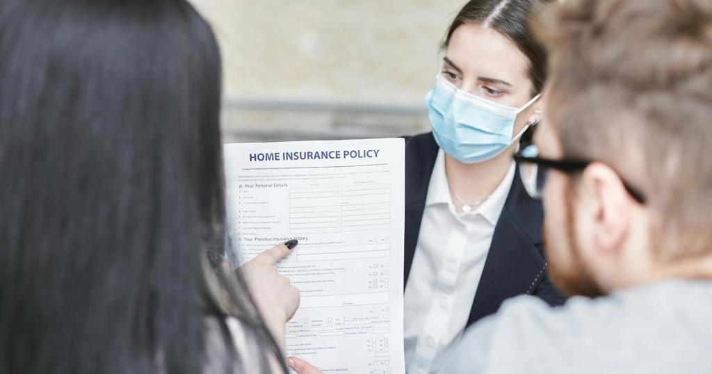A professional woman explains a home insurance policy to clients during a meeting. Indoors setting.
