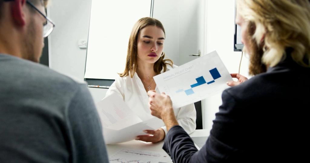 Business team in a meeting analyzing annual profit charts in a modern office.
