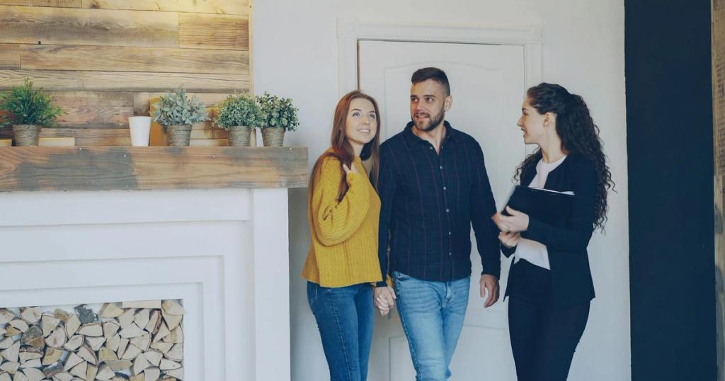 Young couple meeting with real estate agent inside cozy home, exploring purchase options.