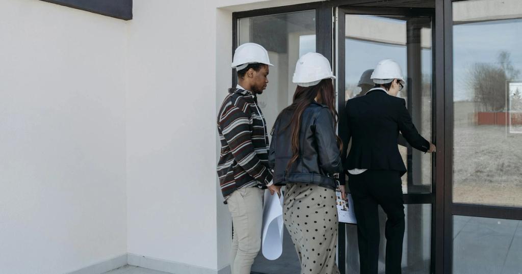 A group of diverse clients with a realtor at a new construction site entrance.