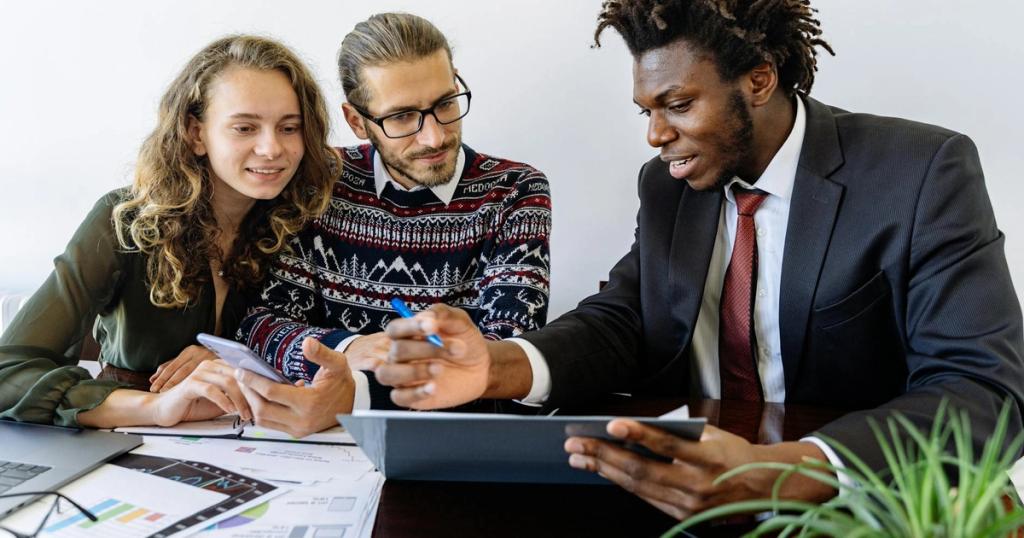 Three professionals engaging in a collaborative business meeting in a modern office environment.