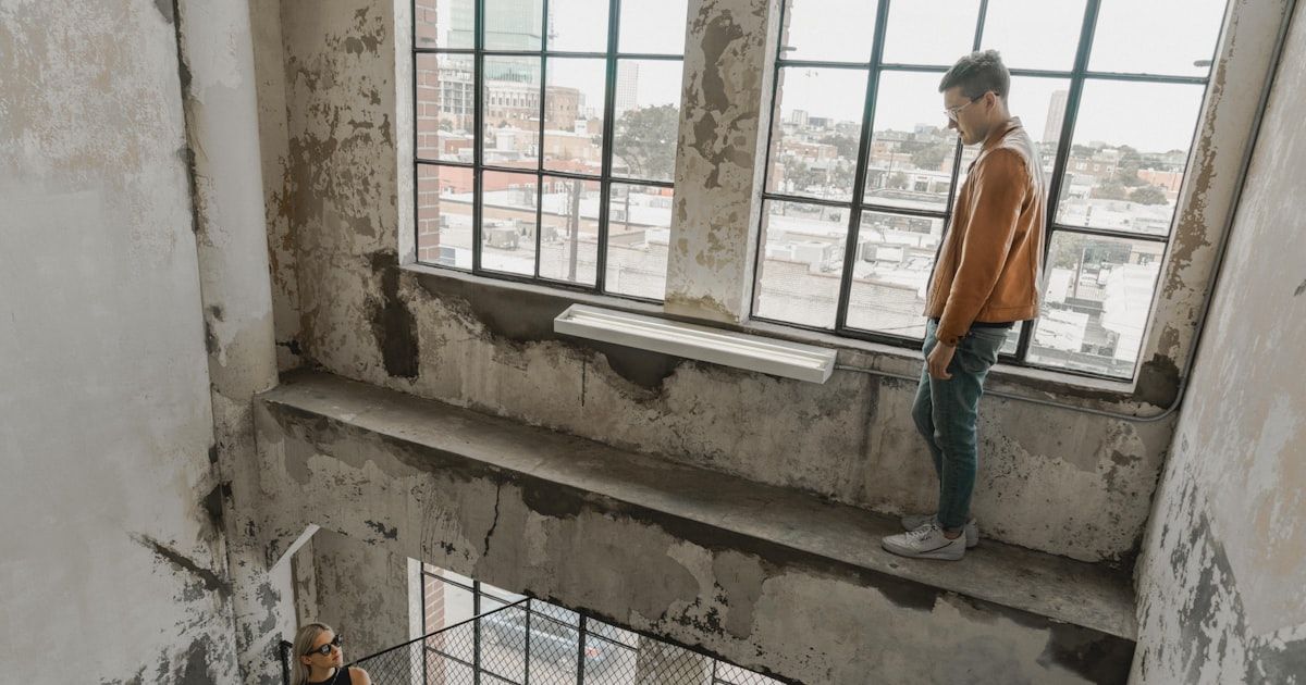 person standing near woman inside building