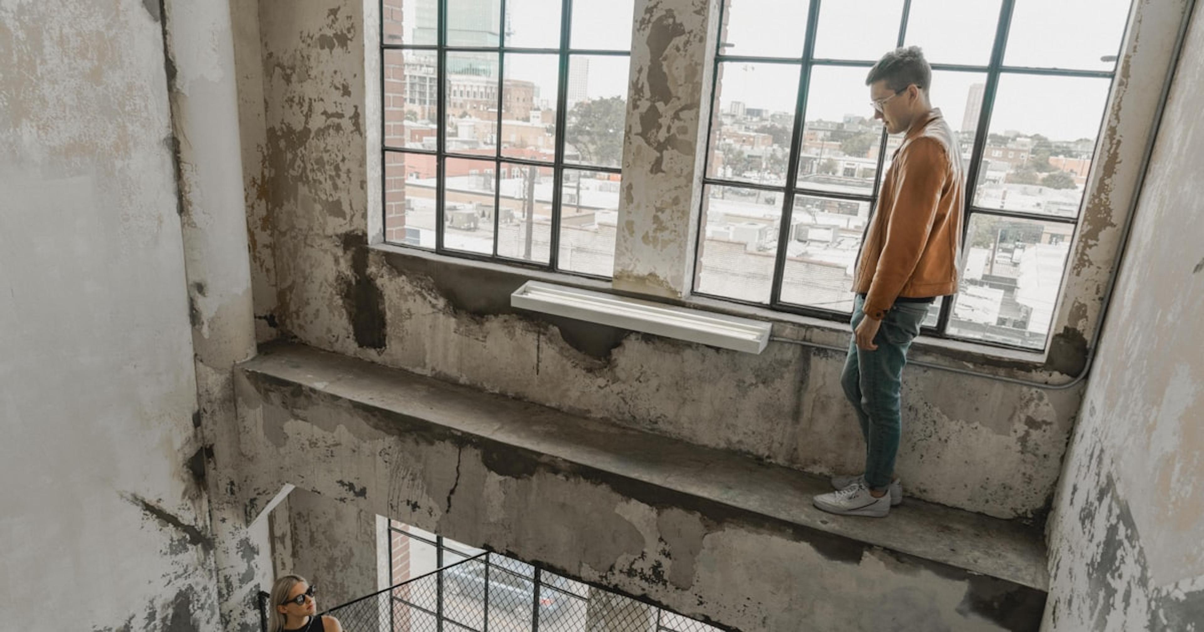 person standing near woman inside building