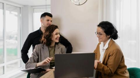 Professional real estate discussion in modern office setting with consultants and clients.