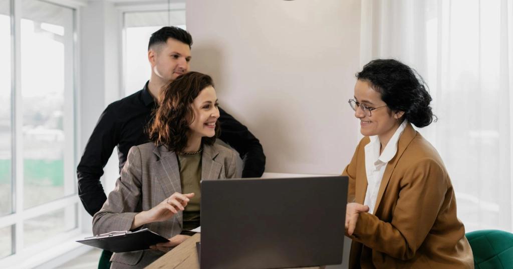 Professional real estate discussion in modern office setting with consultants and clients.