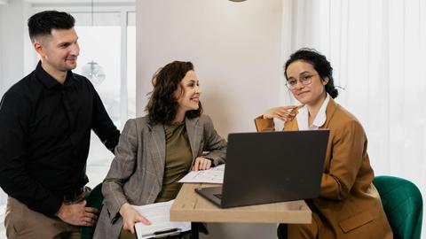 Professional business meeting with real estate consultant and couple in an office setting.