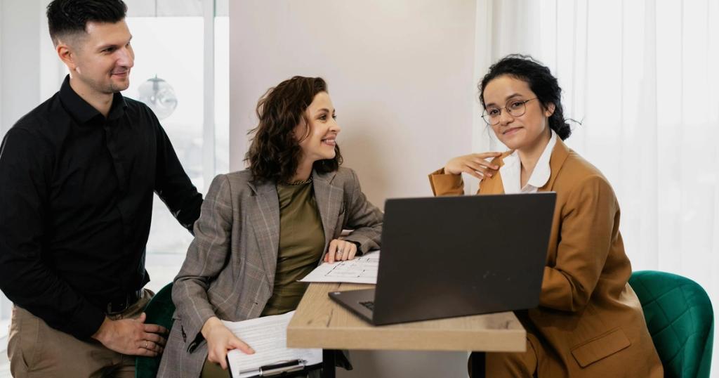 Professional business meeting with real estate consultant and couple in an office setting.
