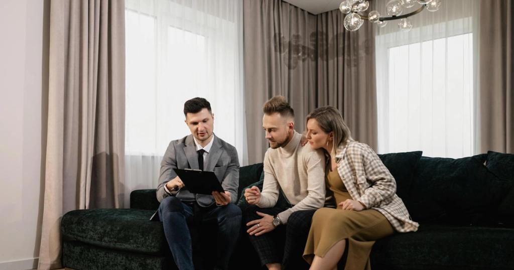 A real estate agent shows a property listing to a couple in a modern living room.
