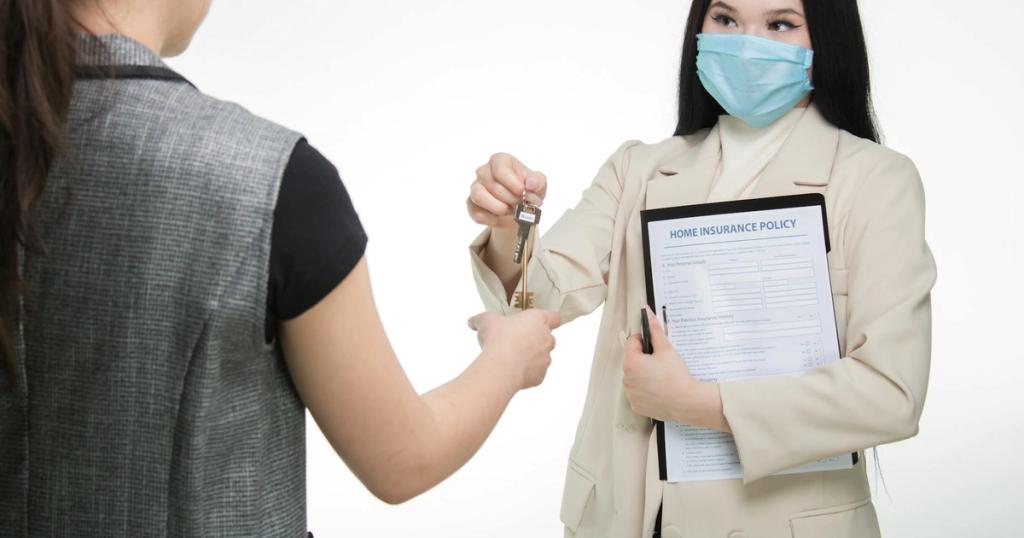 Real estate agent in a face mask hands keys to a client, illustrating safe business practices.