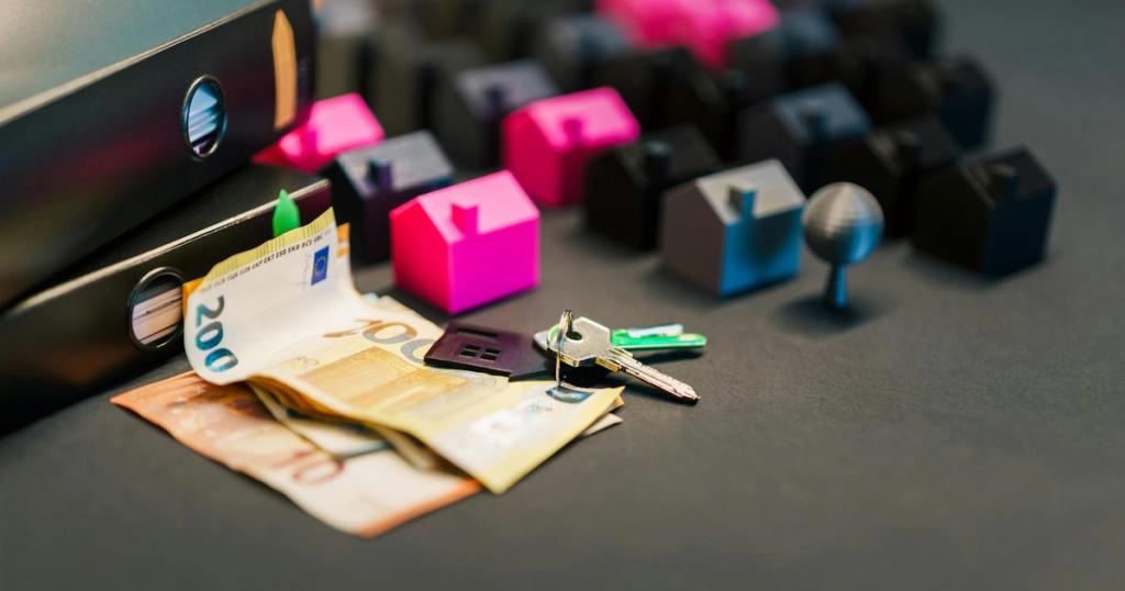 Miniature houses, euro bills, and a house key symbolize real estate investment and property transactions.