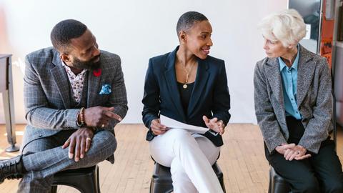 A diverse group of professionals discussing business strategies indoors.
