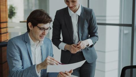Two business people reviewing documents together