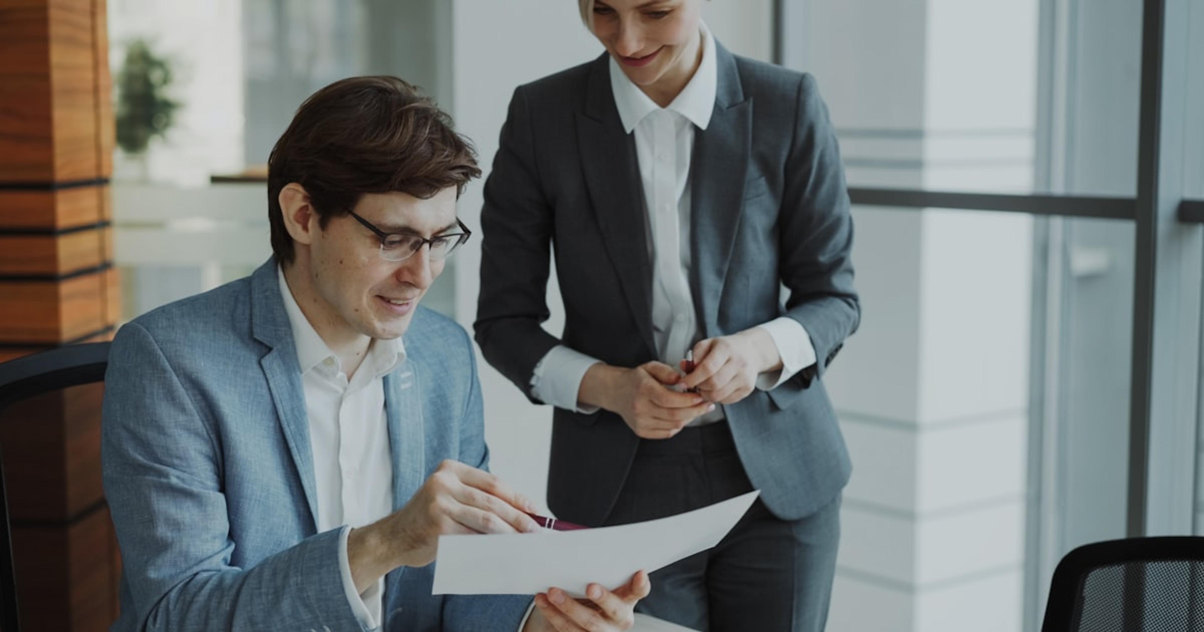 Two business people reviewing documents together