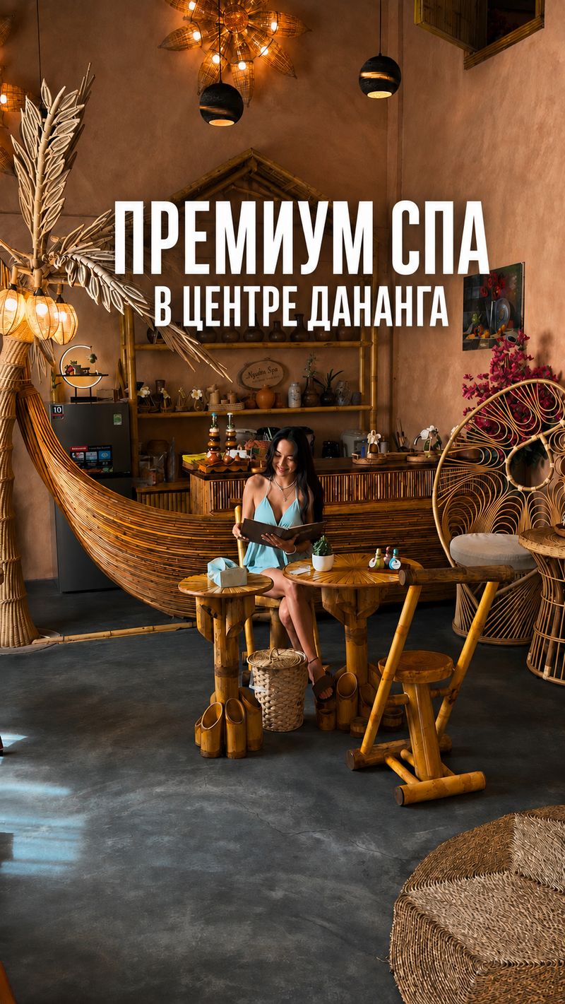 Amanda reading the menu in a spa lounge of bamboo and rattan