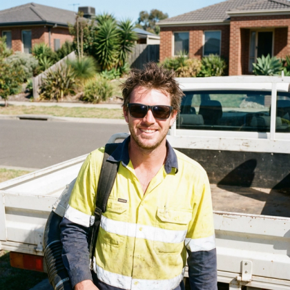 Tradie using a phone at a job site