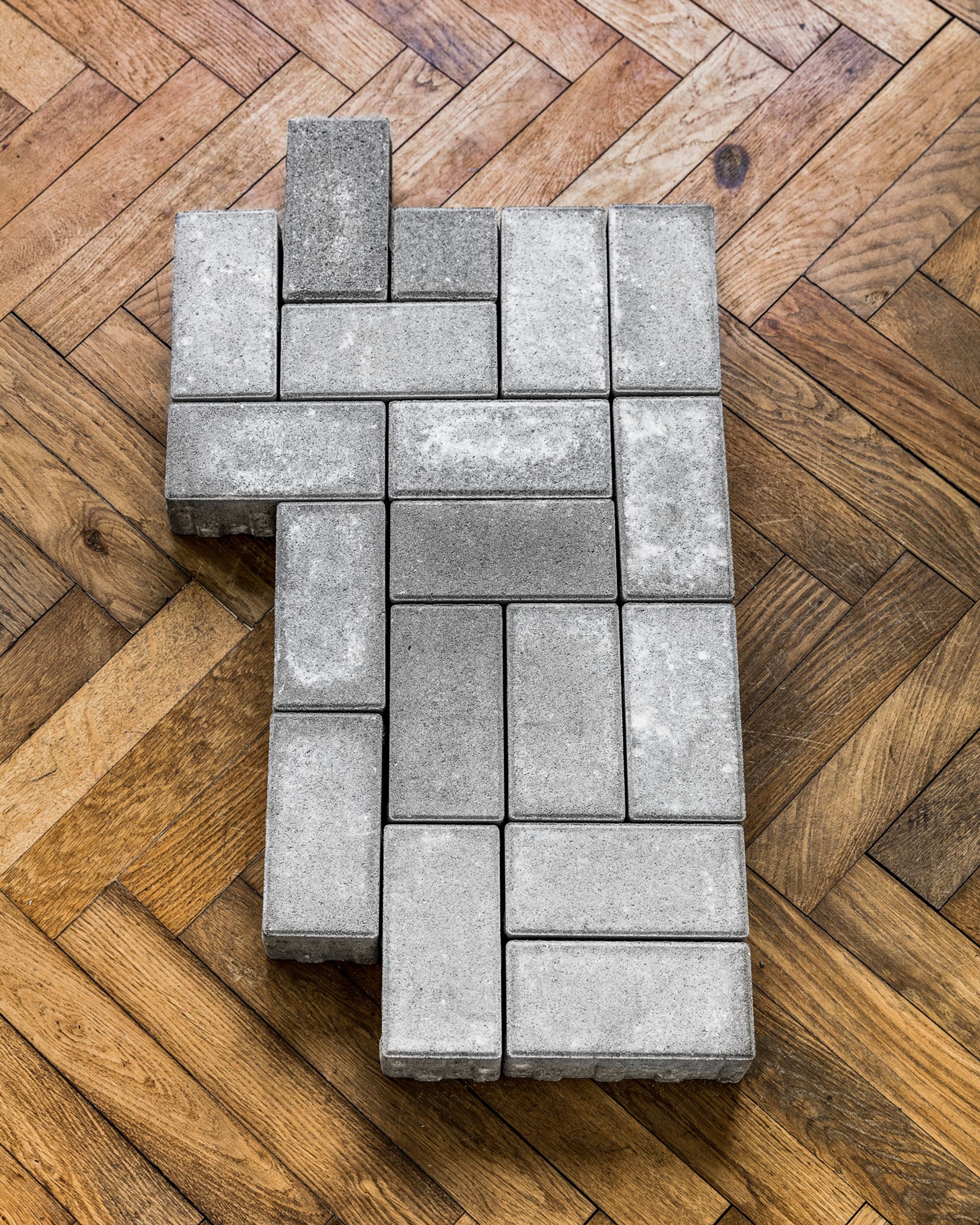 Thomas Geiger, A stage for unscrupulous behaviour, 2017, concrete paving stones, adhesive letters, 90,5 × 49,5 × 8 cm