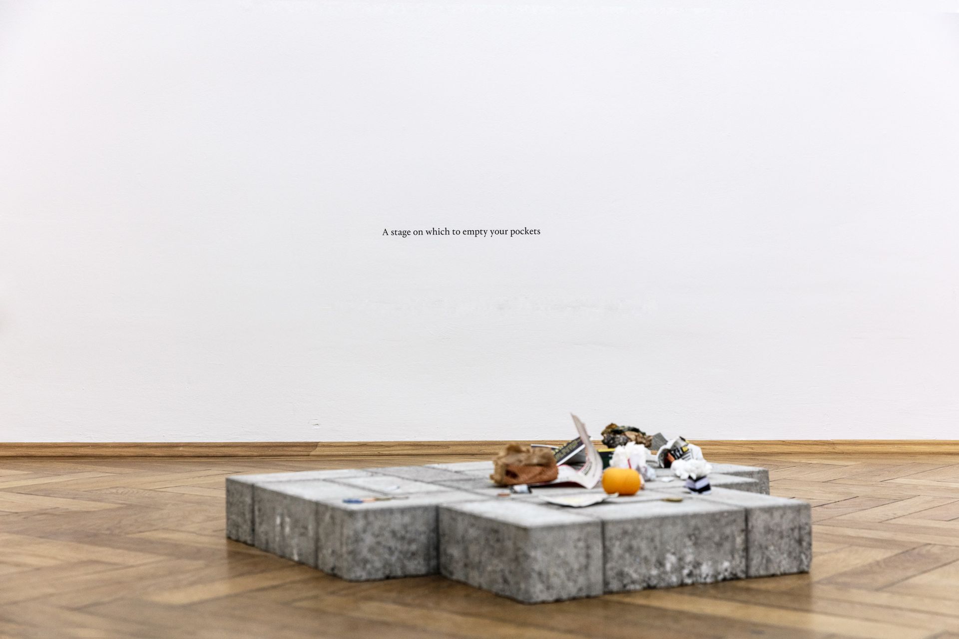 Thomas Geiger, A stage on which to empty your pockets, 2017, concrete paving stones, adhesive letters, 60 × 70 × 8 cm