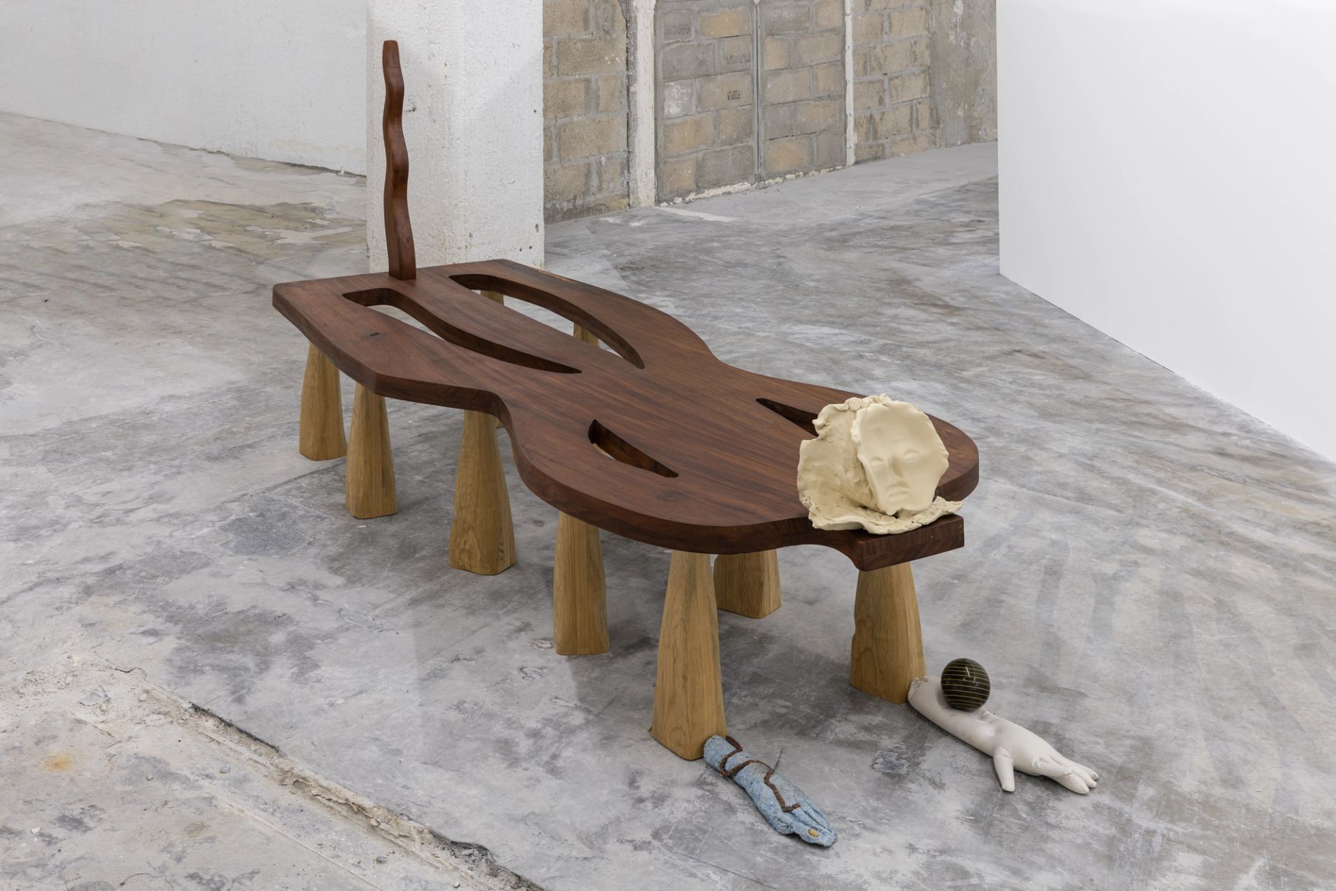 The ultimate love affair (of mud of mind), 2025, tzalam, pine, jesmonite, found object, glue, newspaper, ceramic, bronze, thread, dye, large wooden bench, 220 x 82 x 46 cm