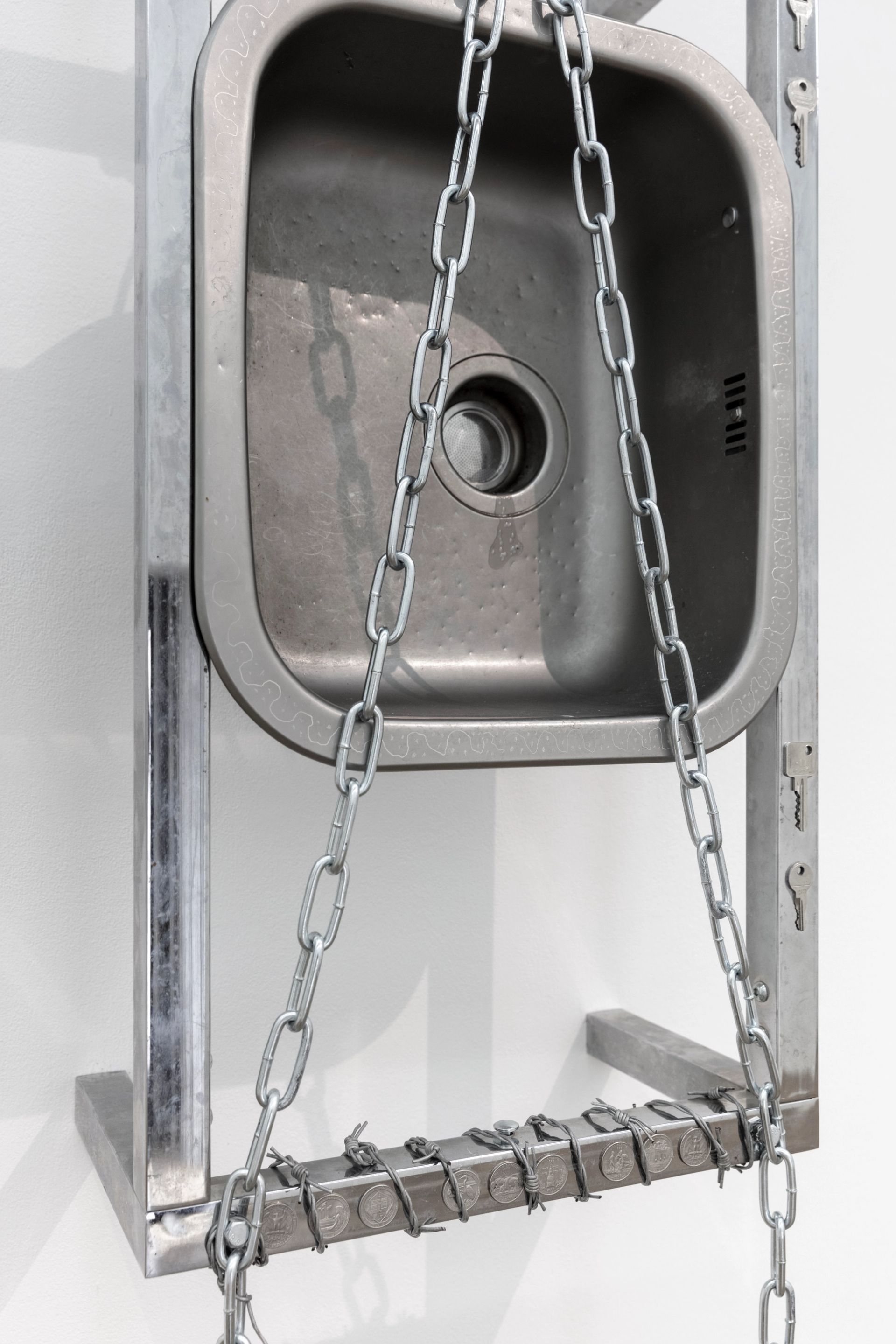 Anna McCarthy, “Shackles / Kitchen”, 2022, stainless steel, chrome, leather, coins, glue, bolts, wire, keys, 145 × 44.5 × 26.5cm