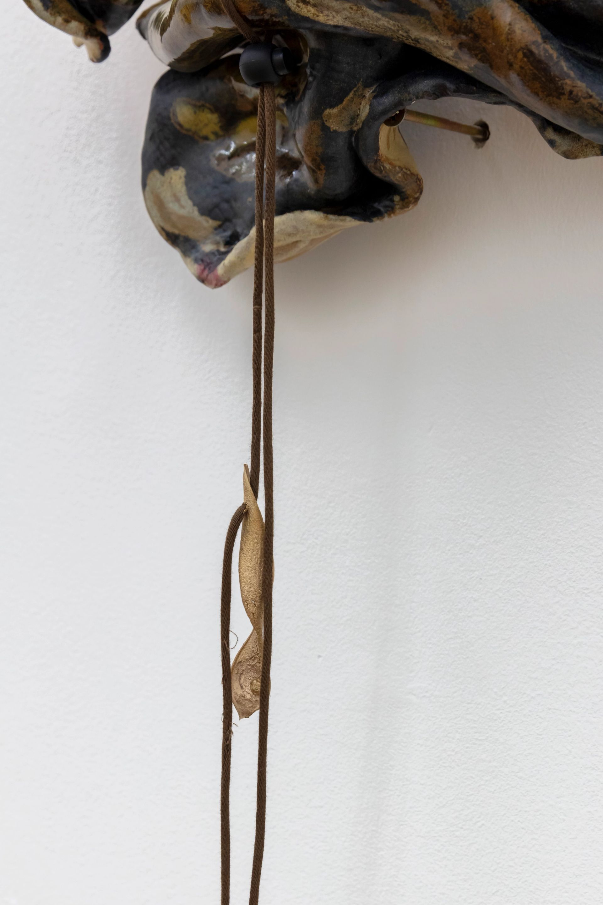 Anousha Payne, Young Snake, 2024, glazed ceramic stoneware, string, found plastic, bronze, approx. 30 × 35 × 15 cm
