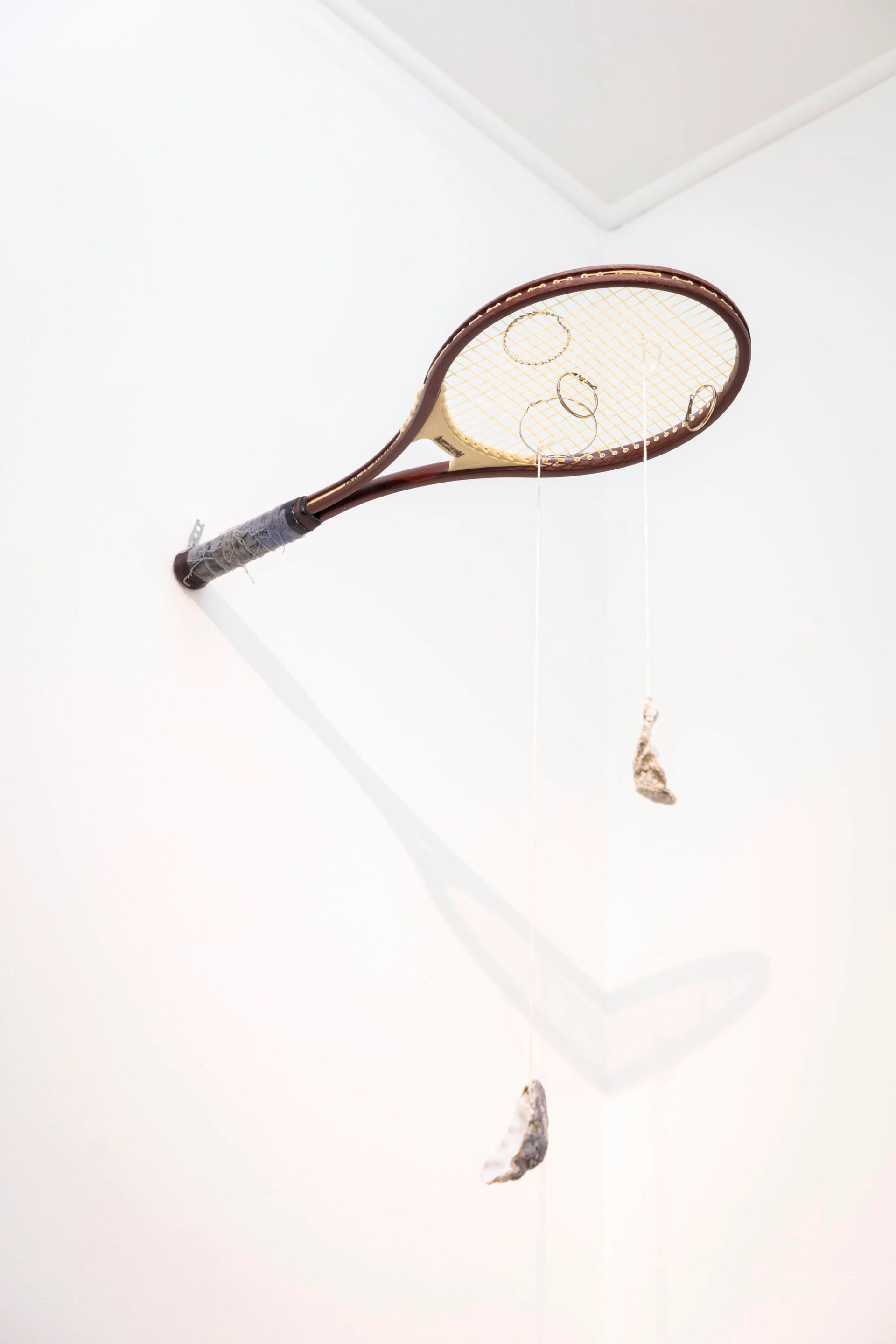 Anna McCarthy, Oyster Tennis, 2020, Tennis racket, jewellery, string, oyster shells, 70 × 60 × 25 cm