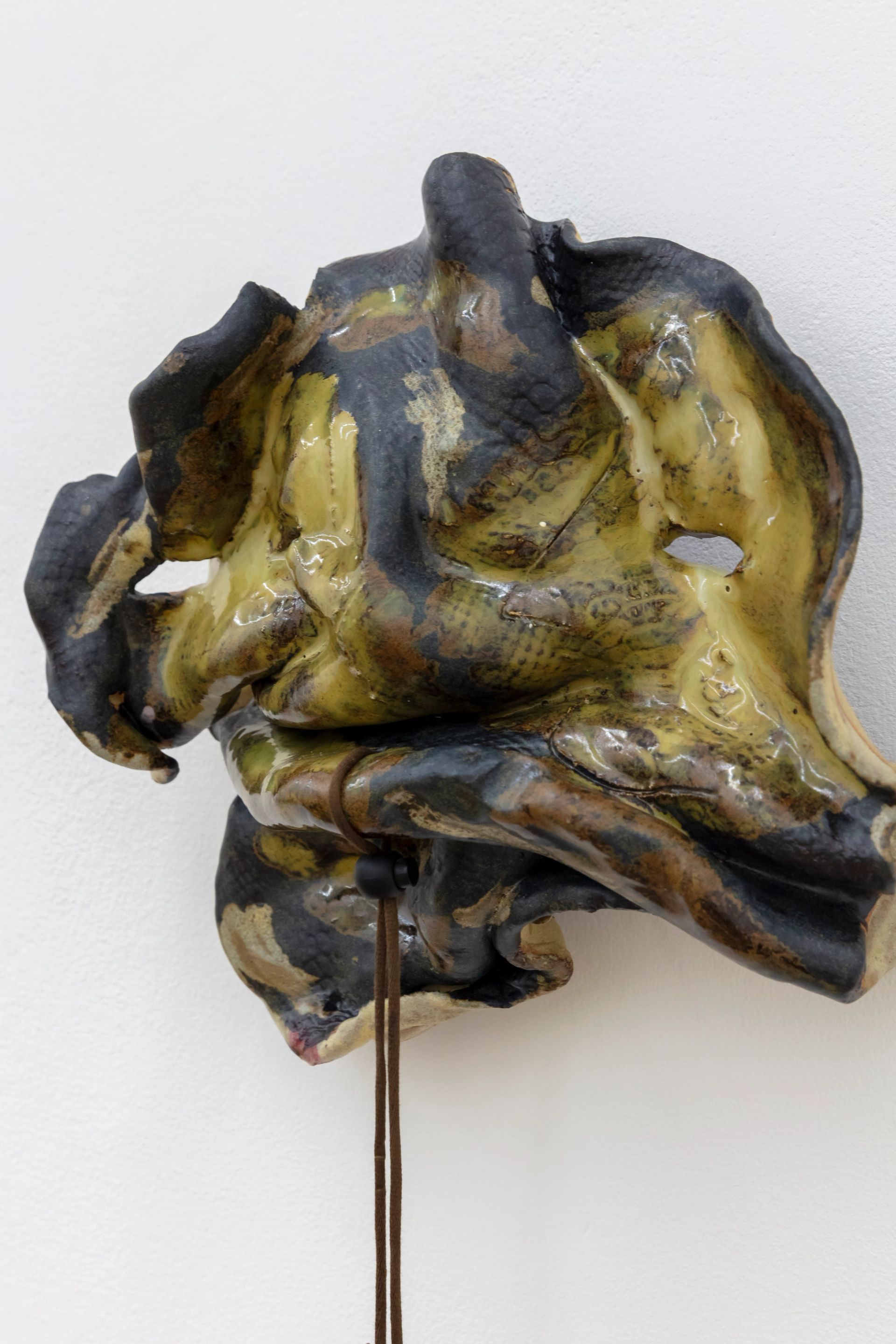 Anousha Payne, Young Snake, 2024, glazed ceramic stoneware, string, found plastic, bronze, approx. 30 × 35 × 15 cm
