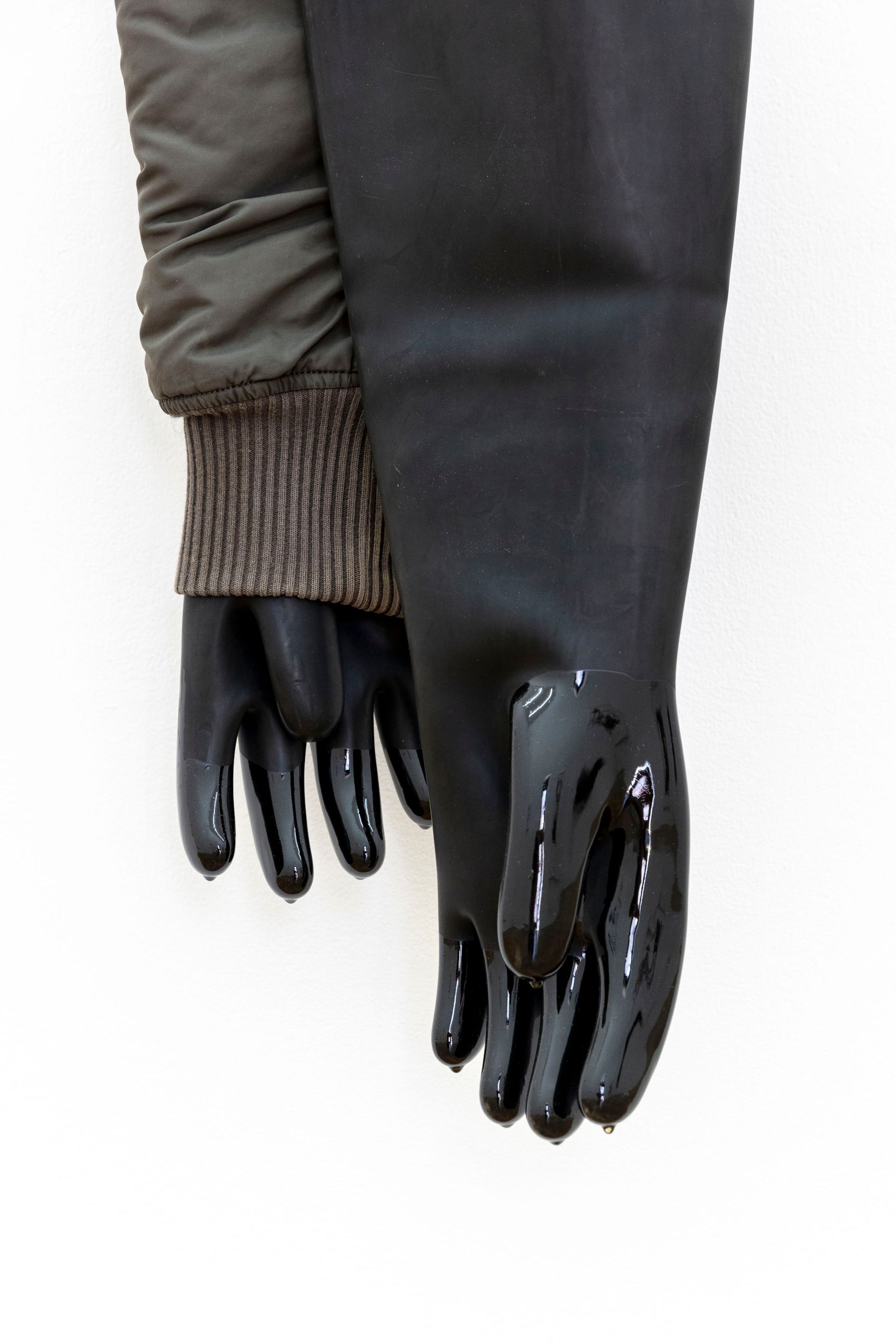 Eher geht ein Kamel, 2023, second-hand clothes, rubber gloves, epoxy, 120 × 15 × 15 cm