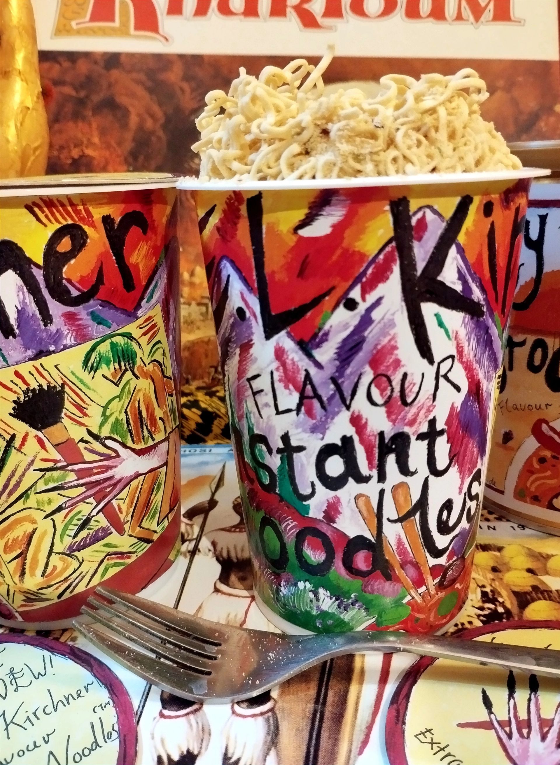 Andrew Gilbert, ,Ernst Ludwig Kirchner Flavour Instant Noodles,, 2024, mixed technique painting on noodle container, 25 × 12 × 12 cm