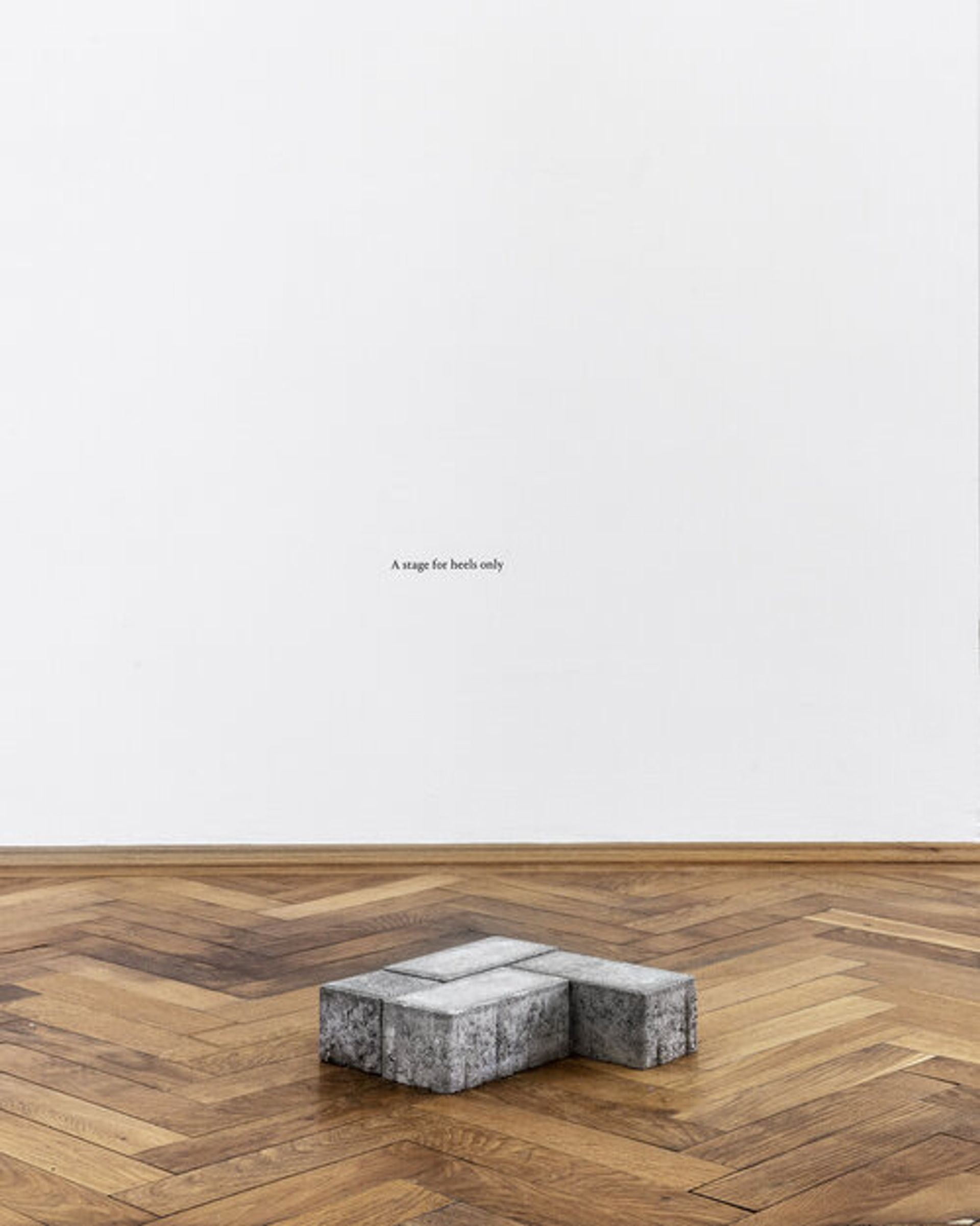 Private Monuments (A stage for heels only), 2017
concrete pavement tiles, adhesive letters, 35,5 × 41,5 × 8 cm. Private Monuments is a series of eight sculptures based on holes of missing bricks on public squares. As a positive of the original holes, they create fragments of public space within a new environment. Eight dedications can be found as instructions to activate these Private Monuments with momentary gestures that are an echo of the daily life on public squares.