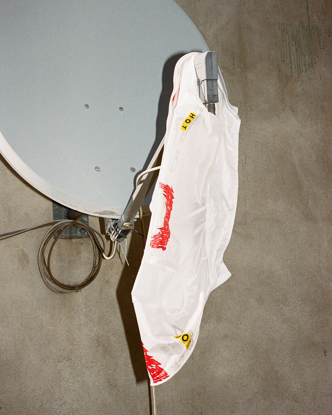 sending unicorn transmissions, a glowing reincarnation gilet hangs from a satellite dish