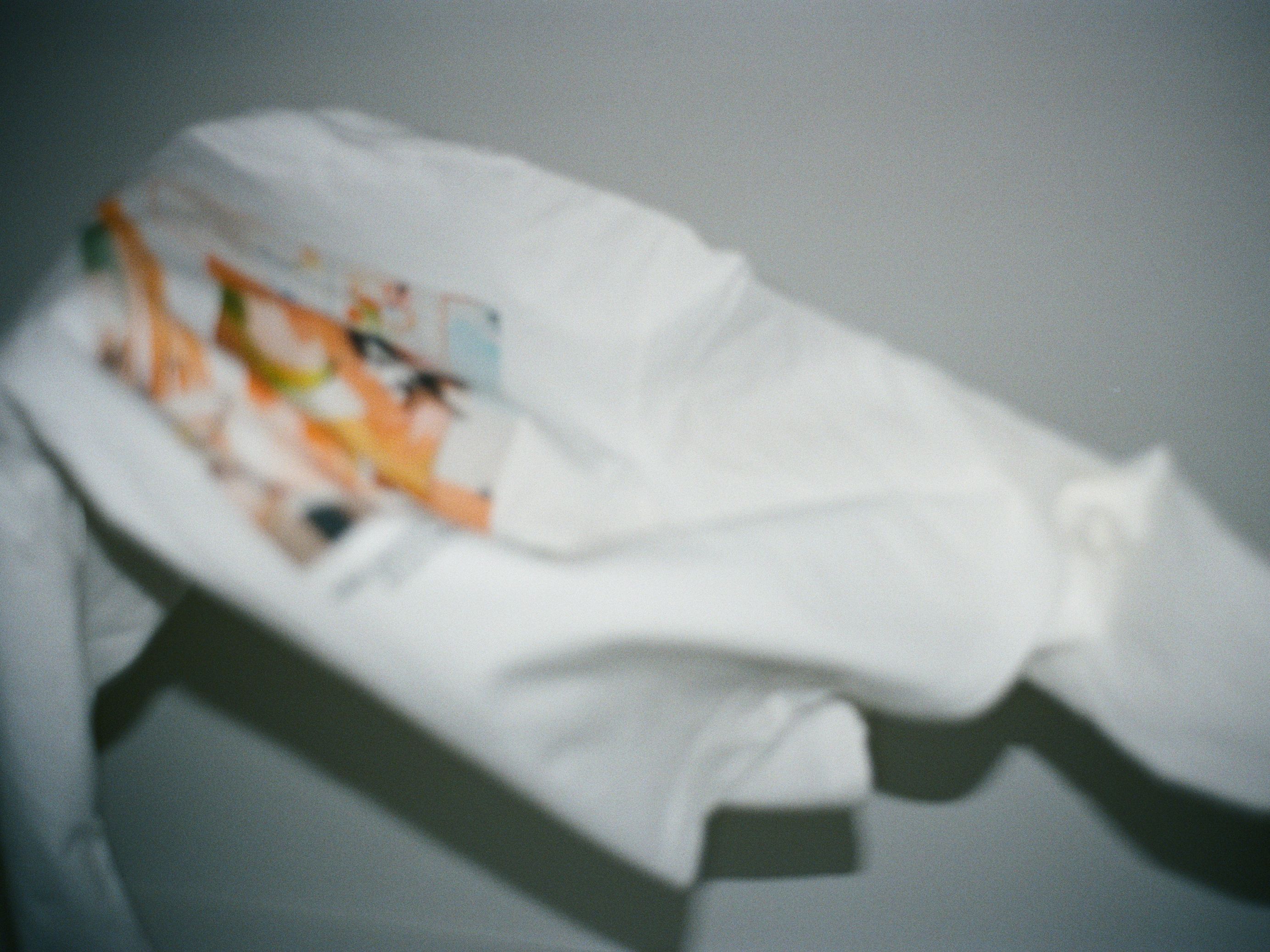 a blurry image of longsleeve shirt jumping in mid air, like the photo print on it where a cat is in mid air