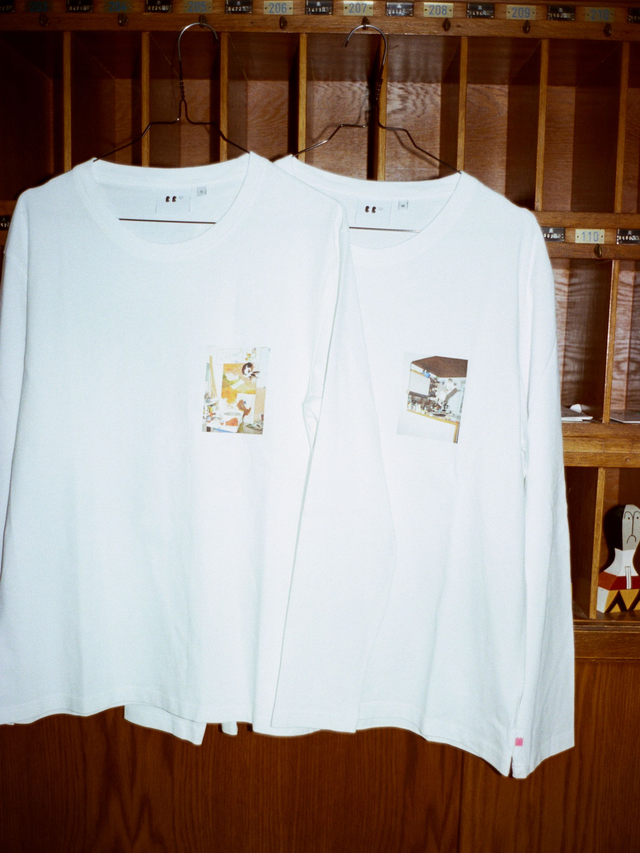 a pair of jumping cats longsleeve shirts hanging at reception in hotel am brillantengrund
