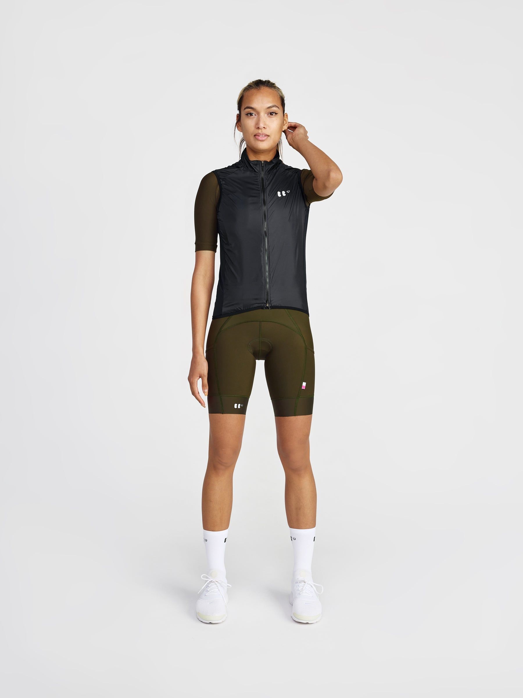 agatha wearing everyone olive jersey and dance bibs in olive, with a dance mesh gilet black over fully zipped