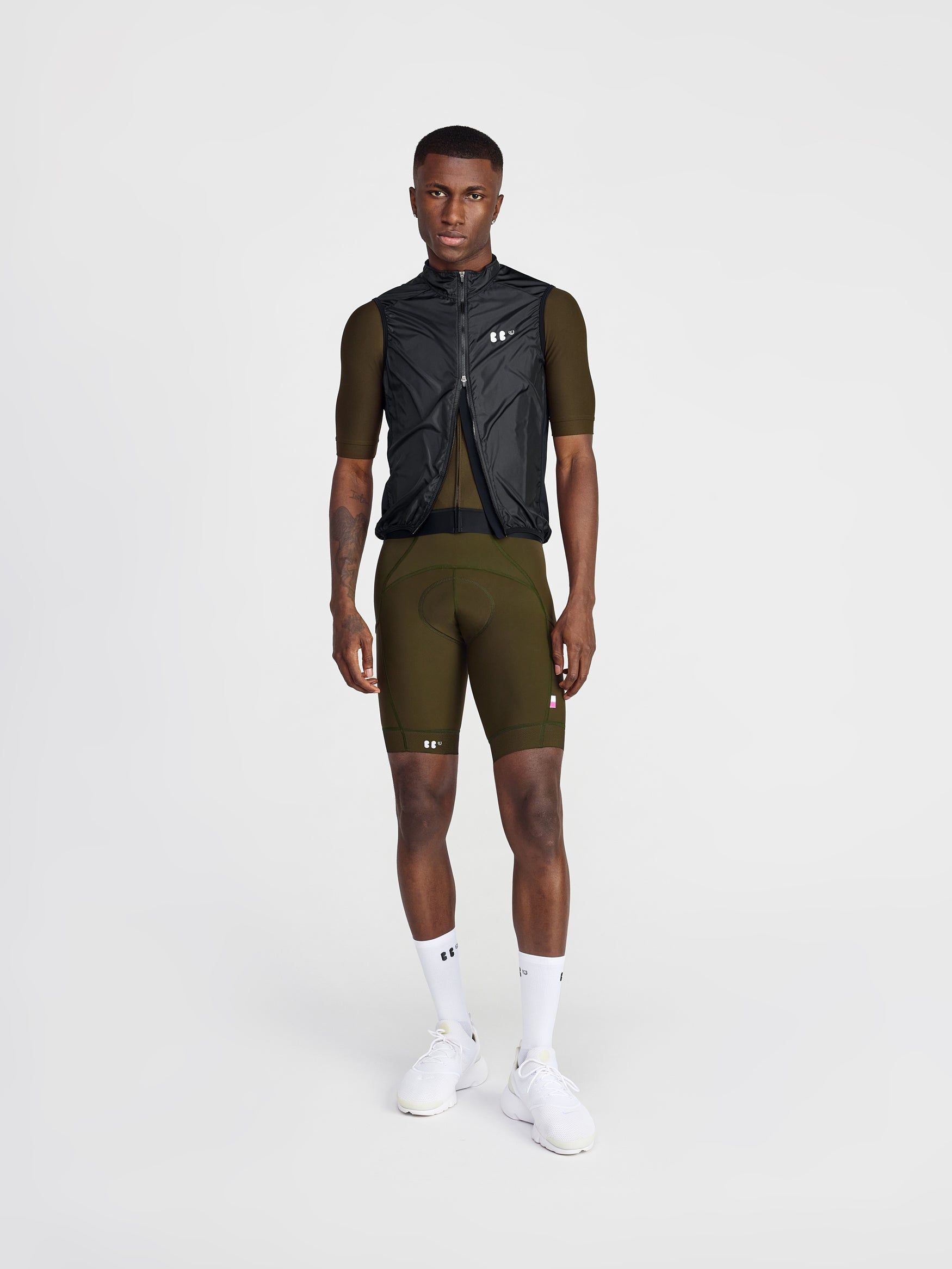 buba in studio wearing everyone jersey olive and dance bibs in olive, with dance mesh gilet in black half zipped