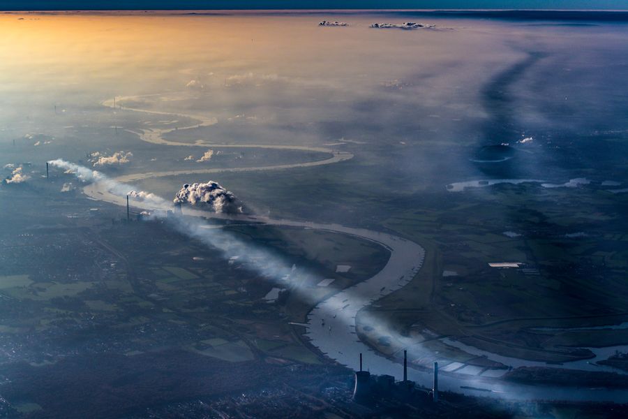 Joe Willems Fotografie dramatische Stadt Luftaufnahme mit Fluss und Industrie 