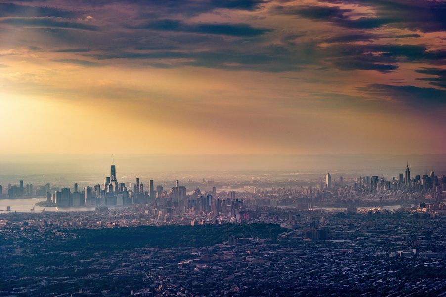 Joe Willems photography dramatic aerial view of New York with clouds and sun