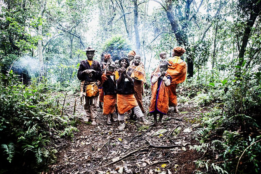 Jörg Conrad Photography group of African children in orange clothing in the forest