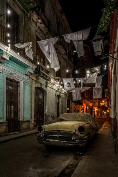 Joe Willems Photography beige vintage car in dark little alley hung with white linen and lit with fairy lights