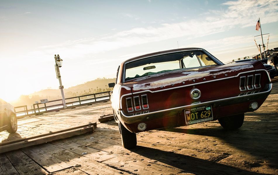Georgia Ortner Photography dynamic shot red Mustang from behind in sunset on deck
