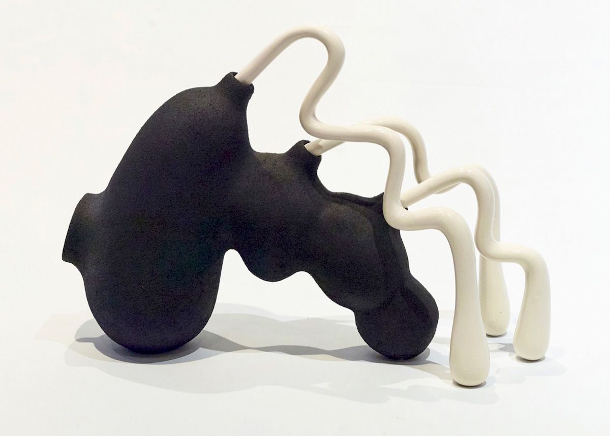 Pe Hagen abstract sculpture black ant without legs and white tubes protruding from the back