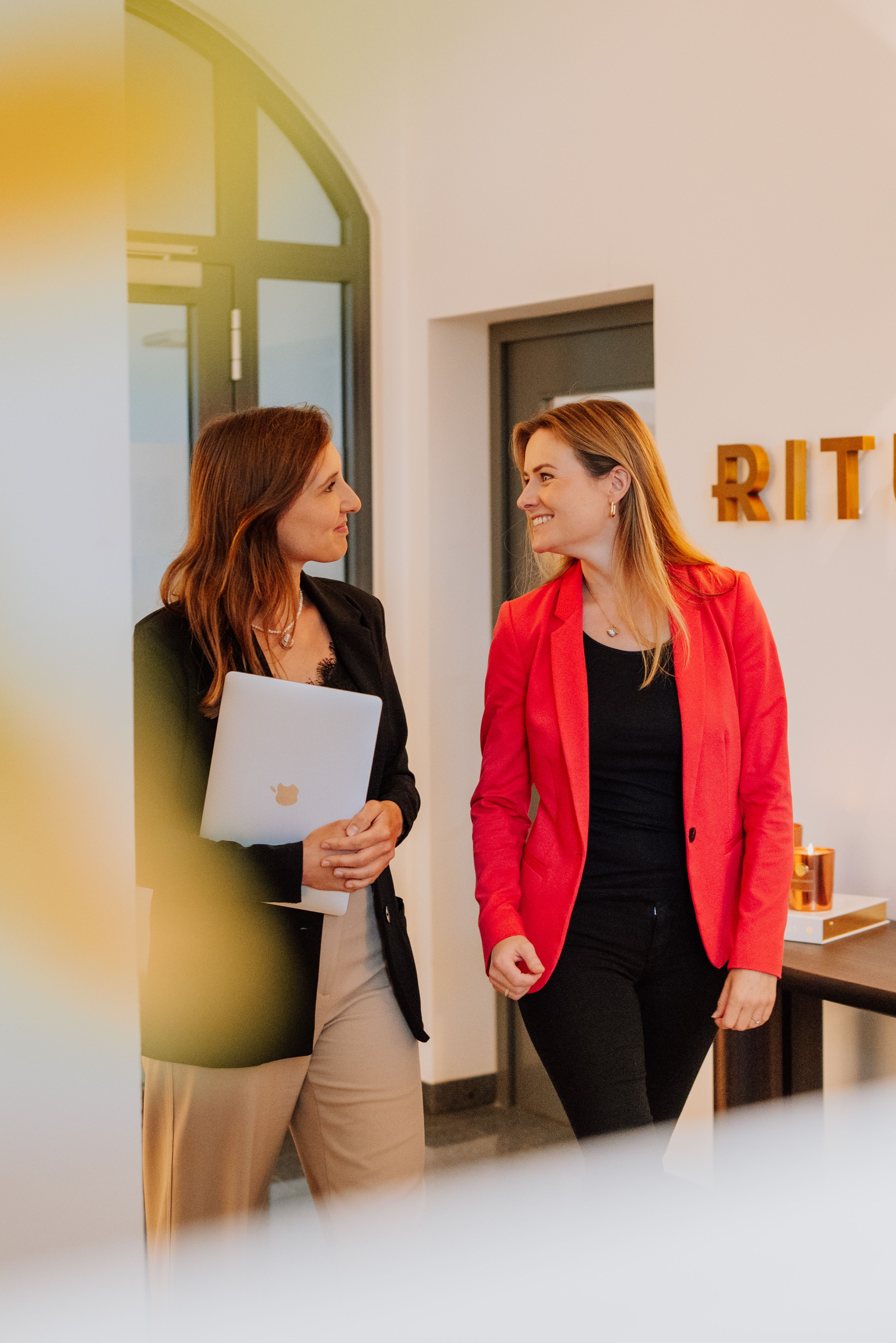 Two employees walking in the office
