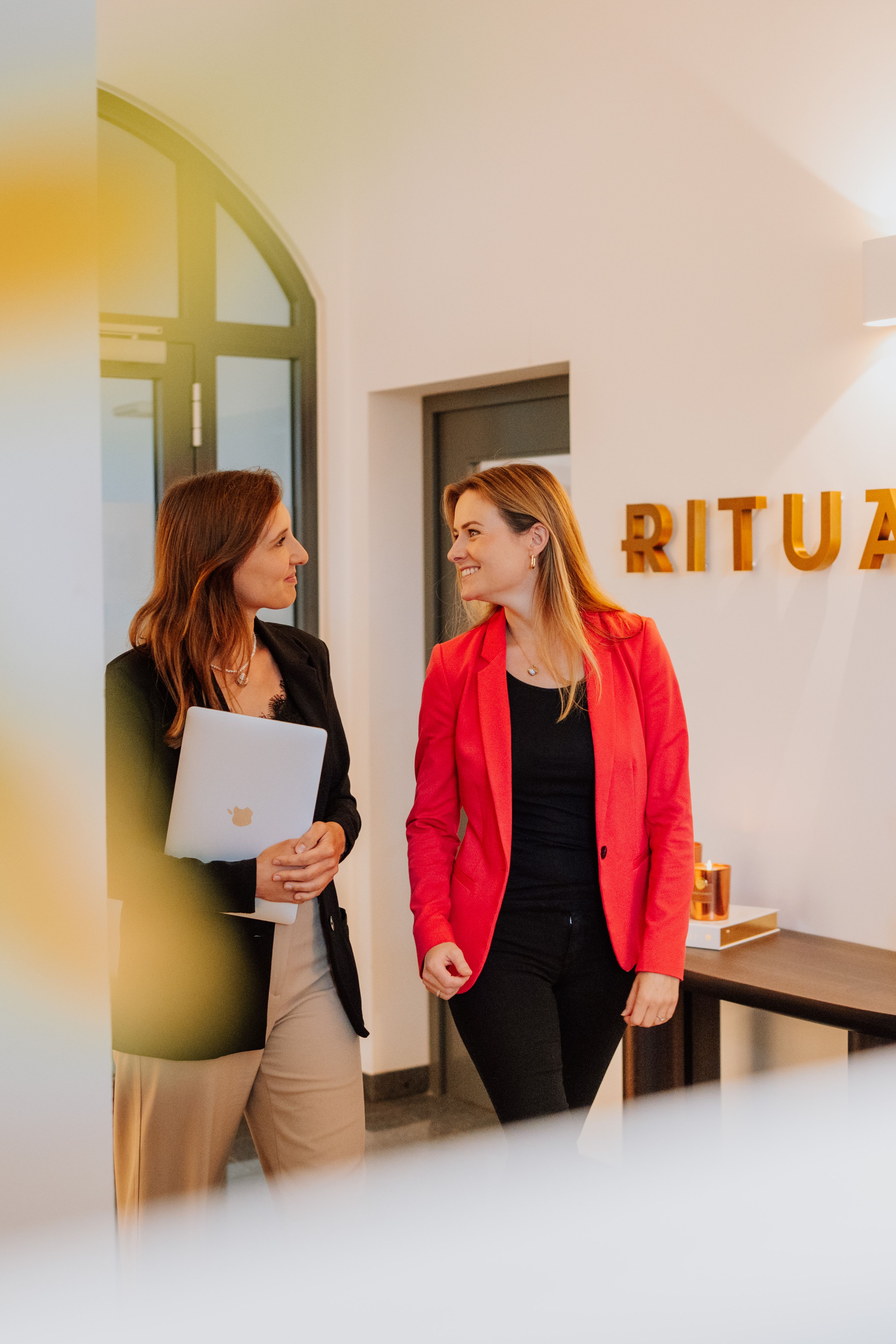 Two employees walking in the office