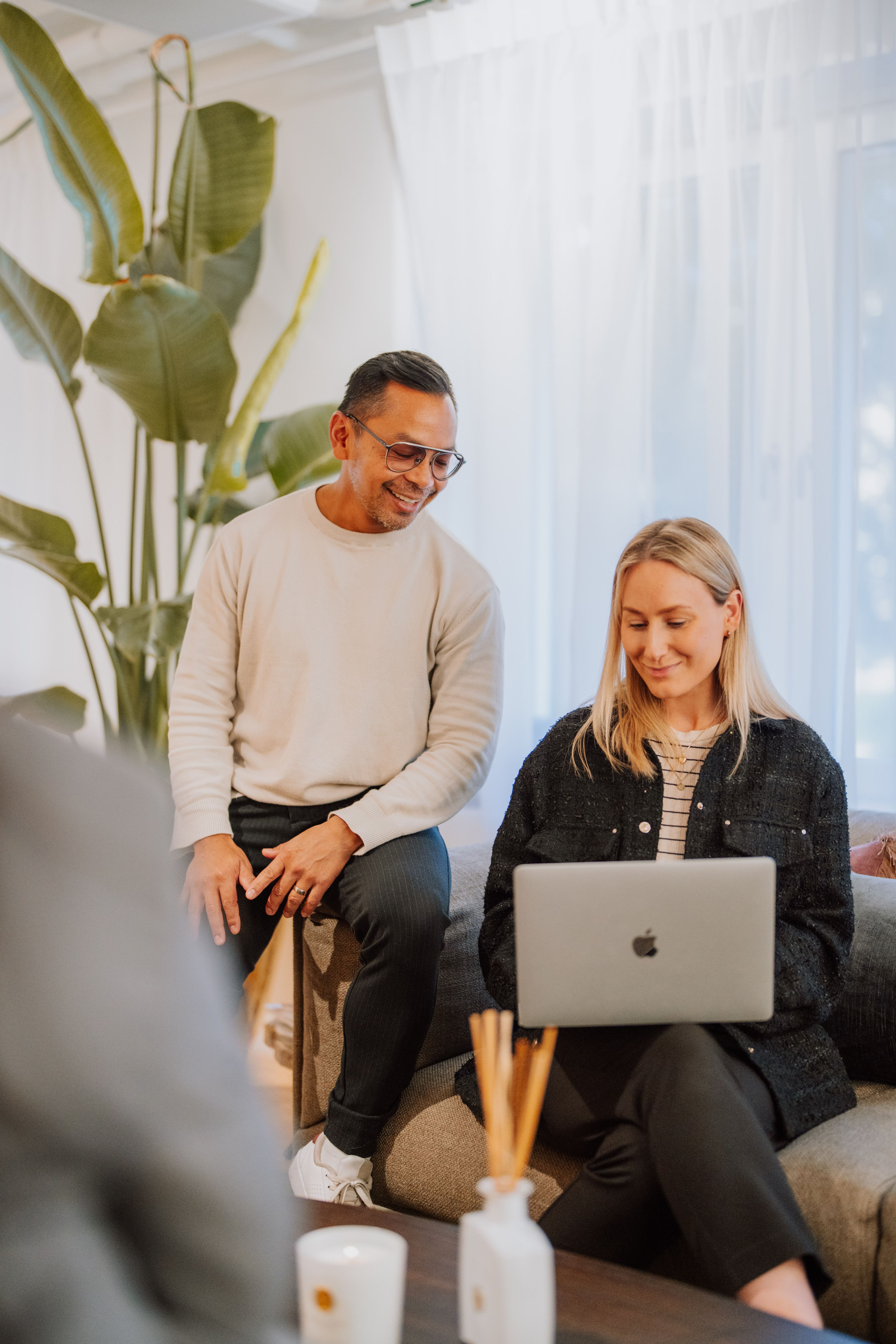 Two employees behind a laptop