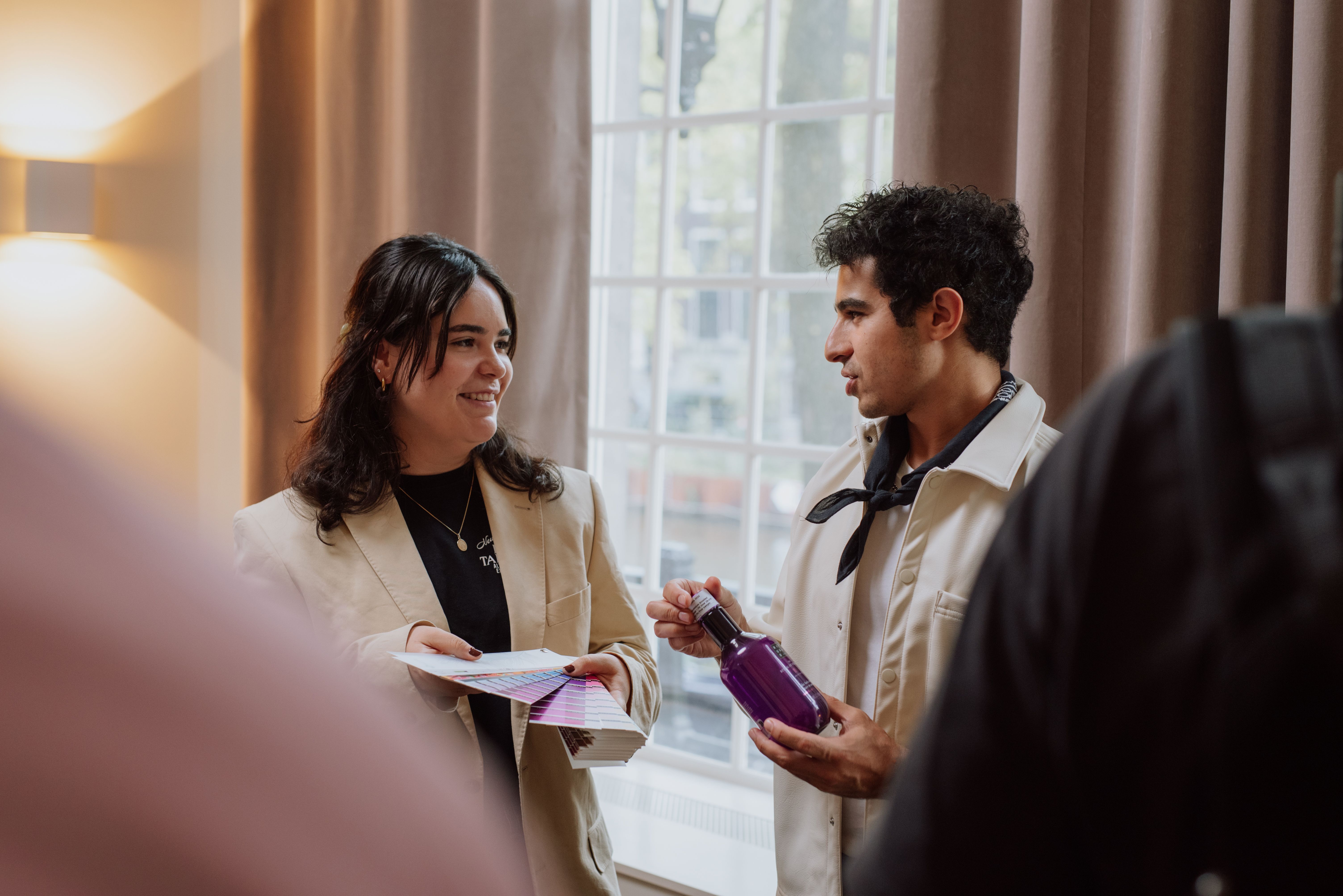 Two employees discussing products