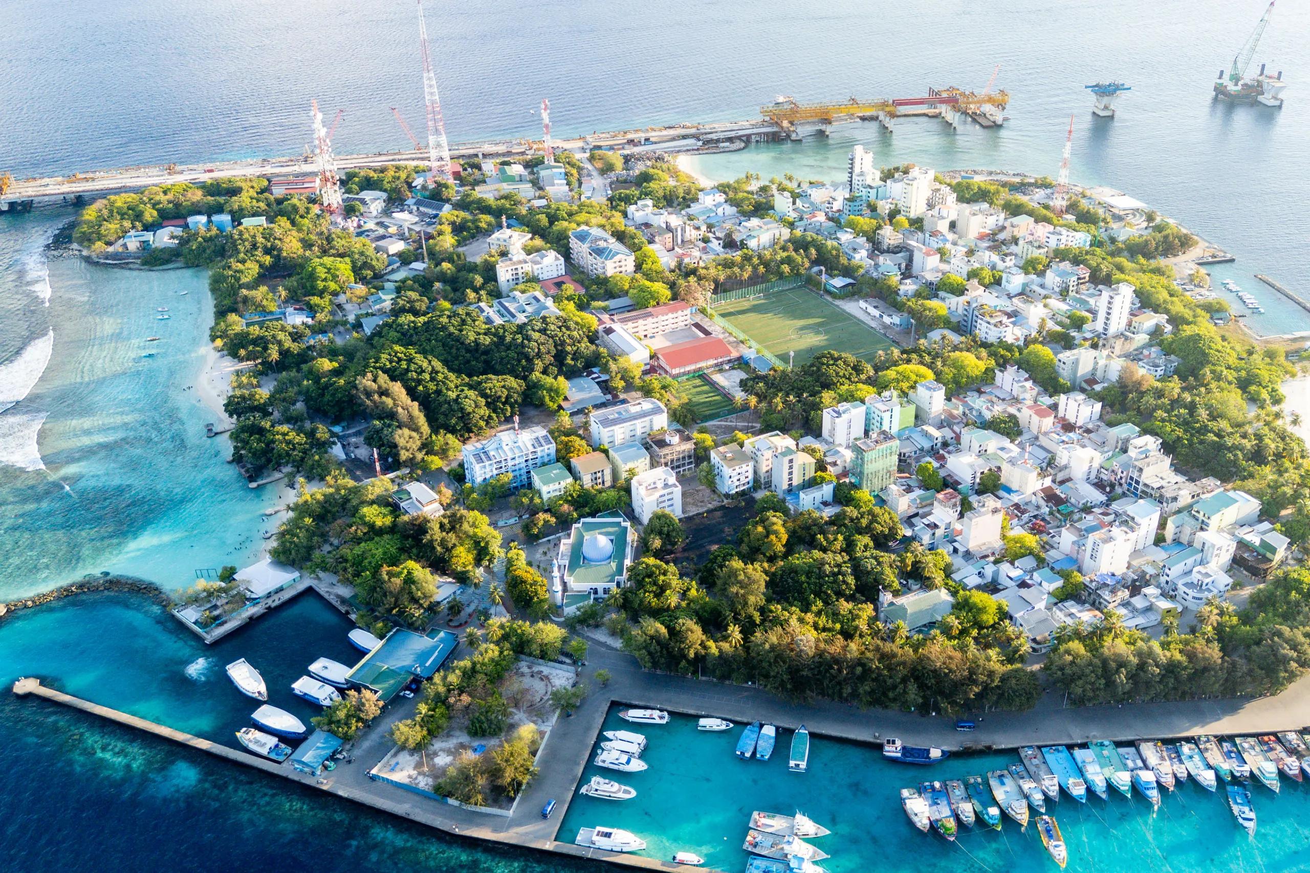 Drone view of Vilimalé surrounded by shallow turquoise reef